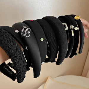 Elegant black padded headband set with pearls, rhinestones and golden heart details