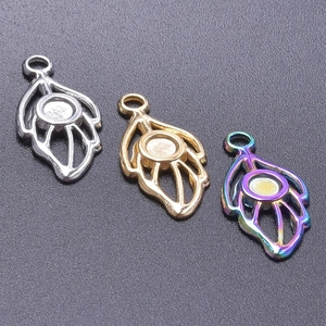 Detailed view of stylized leaf jewelry pendants in silver, gold, and rainbow finish