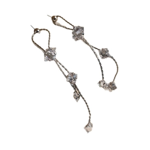 Silver zircon tassel earrings with star rhombic drop chains on a white background