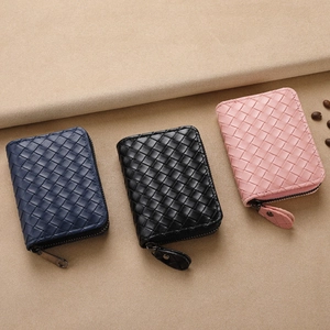 Three woven leather card holders with zippers in navy blue, black and pink colors