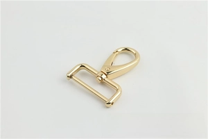 Close-up of pale gold metal lobster clasp with rotatable D-ring for handbag straps