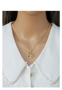 Macro detail of Tree of Life pendant with colorful zircons on gold chain for women