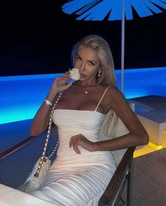 Detail of white ruched bodycon maxi dress with spaghetti straps and elegant draping