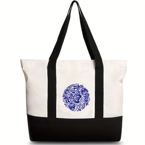 Black and white canvas tote bag with a blue floral print and spacious shoulder straps