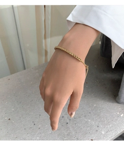 Adjustable gold woven chain bracelet shown on woman wrist for an elegant minimalist look