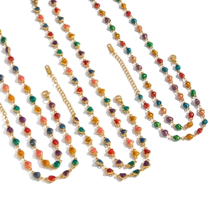Three gold necklaces with colorful heart-shaped charms on a clean white background