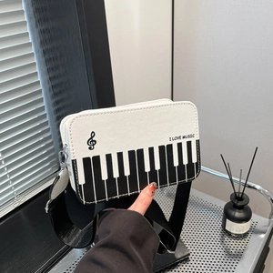 Piano key contrast shoulder bag with I LOVE MUSIC print and wide strap for daily style