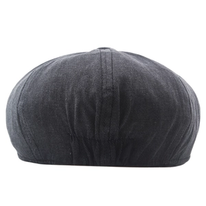 Detail view of washed cotton fabric texture and elastic back strap on a newsboy cap