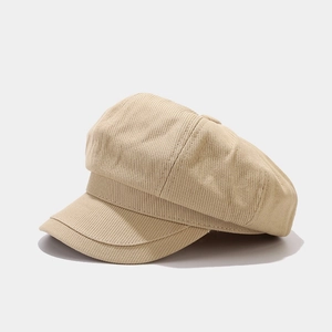 Macro detail of the beige corduroy fabric texture on a vintage newsboy octagonal hat