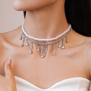 Close-up of double layer necklace with pearls and sparkling zircon water drop charms