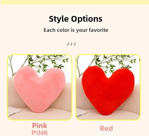 Detailed comparison of pink and red heart-shaped plush pillows in a cozy home setting