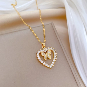 Luxurious gold heart pendant necklace with crystal butterfly on champagne silk backdrop