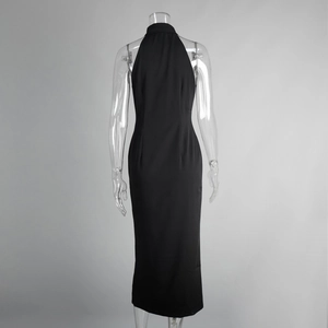 Detail of the back of a slim-fit black halter maxi dress with waist structural lines