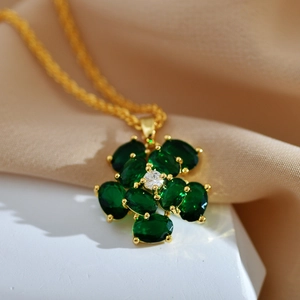 Elegant gold-plated flower pendant necklace with green stones and a white zircon center