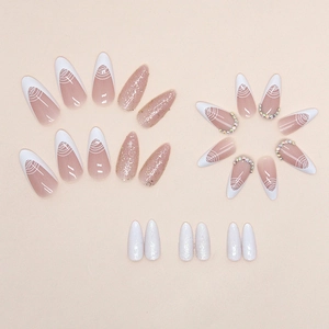 French tip press-on nails with white spiral lines, pink glitter and crystal accents
