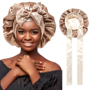 Golden satin sleeping bonnet with oversized bow and long ribbons for hair protection