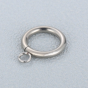 Minimalist stainless steel circle pendant with small ring connector on gray background