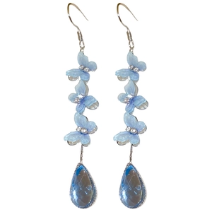 Blue butterfly tassel earrings with rhinestones and teardrop crystals on white background