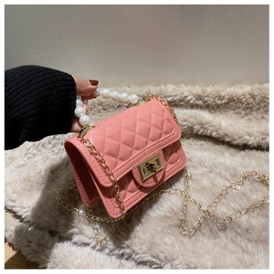 Detail of pink silicone jelly bag featuring quilted pattern and faux pearl handle