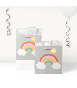 Detail of grey gift bags with rainbow patterns and a smiling sun tag in a party setting