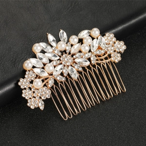 Elegant rose gold bridal hair comb with marquise crystals and white pearls on black background