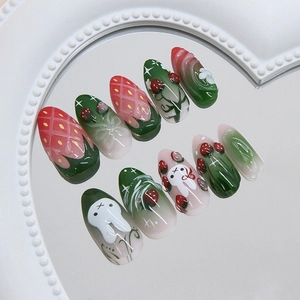 3D strawberry and bunny press-on nails set with floral accents on a heart mirror