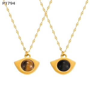 Detail of fan-shaped pendants with brown tiger eye and black onyx on gold chains