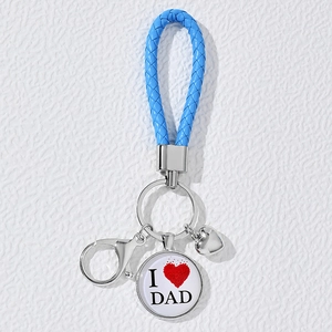 Close-up of blue braided leather keychain with I Love Dad glass pendant and silver charms