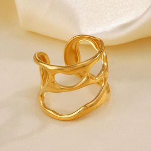 Irregular gold hollow ring with organic wave design on a silk background