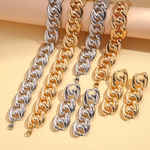 Detail of chunky Cuban chain jewelry sets in gold and silver finish with earrings