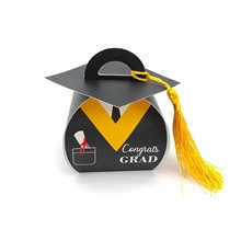 Close-up of graduation cap gift box with Congrats GRAD text and yellow tassel detail