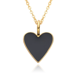 Macro detail of 14K gold plated heart pendant necklace with black enamel inlay