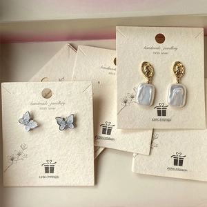 Detail showing butterfly earrings and pearl pendant on S925 silver jewelry display cards