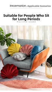 Detail of plush shell pillows in yellow, pink, and blue on a sofa with cozy home decor