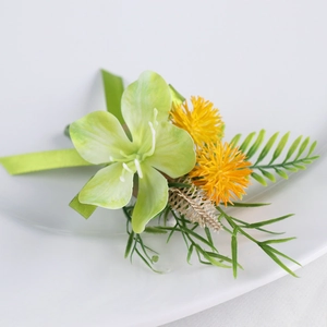 Elegant artificial wedding boutonniere with green orchid and yellow floral accents