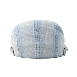 Rear view of a light blue washed denim newsboy cap with precise stitching and metal buckles