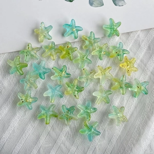 Close-up of gradient starfish beads with golden glitter for DIY jewelry making
