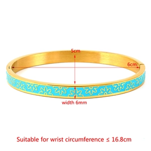 Golden stainless steel bangle with light blue enamel daisy flowers and open clasp