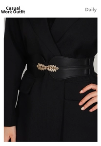 Close-up of black elastic waist belt featuring a gold leaf metal buckle on a blazer