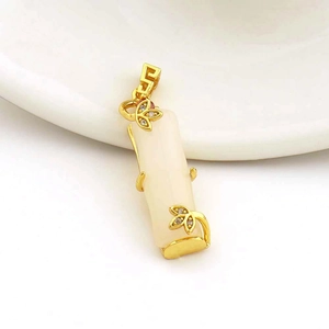 Detail of 18k gold plated bamboo pendant with white jade and micro-set zircon accents