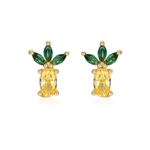 Macro view of pineapple-shaped earrings with yellow zircon crystals and green leaves