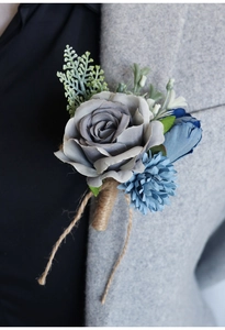 Close-up of vintage dusty blue rose boutonniere pinned on a gray wool suit lapel