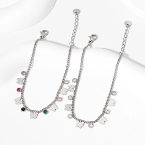 Elegant silver butterfly bracelets with colorful cubic zirconia on geometric white background