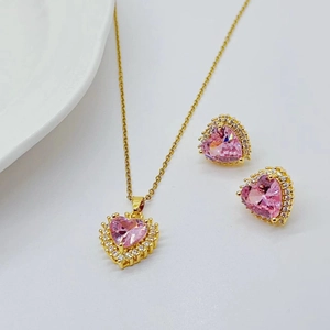 Golden necklace and earrings set with pink heart-shaped zircons and clear crystals