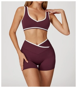 Detail of high-waisted yoga set featuring crossover waist and white contrast binding
