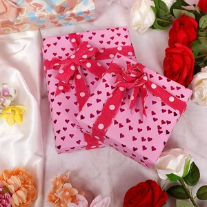 Pink heart pattern gift wrapping paper with ribbons and flowers for Valentines Day