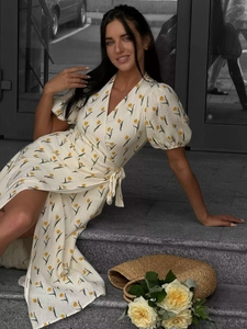 Detail of floral wrap dress featuring yellow tulips, puff sleeves, and waist tie ribbon