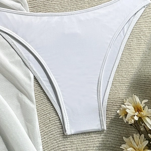 Detail of white bikini bottoms with high-quality stitching and elastic fabric texture