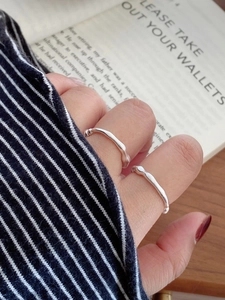 Close-up of S925 sterling silver beaded rings with irregular wave texture on a hand