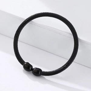 Detail of black twisted cable magnetic therapy bracelet with polished bead end caps